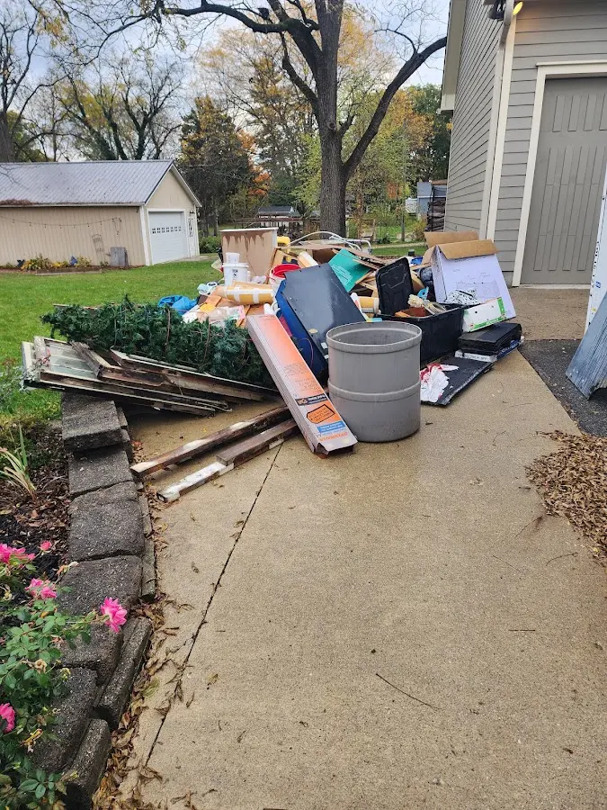 Dumpster being loaded with debris for Estate Cleanout Dumpster Rental in Brambleton